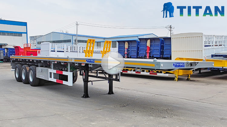 Video of Heavy Duty Flatbed Trailer  Heavy Duty Flatbed Trailer in Mali Price: 9700 USD The flatbed trailer is specifically designed for road transport of standard containers and is commonly used in ports, logistics centers, and similar settings. Due to the versatility, ease of loading and unloading, and cost-effective operation, the heavy duty flatbed trailer for sale is widely utilized in modern logistics and transportation. Additionally, the 40 ft flat bed trailer is also suitable for carrying bulk cargo, making a flexible solution for various transport requirements.  Specification of Flat Bed Trailer Overall Dimension: 12500mm*2500mm*1590mm Load Capacity: 60 ton Floor Plate: 3mm thick pattern floor plate Side Beam: 160mm high Axles: 3 axles, 13ton Tire: 12 units, 12R22.5 Landing Gear: 28 ton Suspension: mechanical suspension Leaf Spring: 10 layers Lamp: LED Lamp with anti-theft design Bumper: 4mm thick   Advantage of Flatbed Trailer The flatbed trailer emphasizes the combination of practicality and durability during the design process, targeting to improve the performance of heavy duty flatbed trailer for sale and adapt to transportation tasks in different regions and working conditions.  In order to further enhance the firmness of the structure, the beam of the heavy duty flatbed trailer for sale adopts automatic submerged arc welding technology to make the connection parts tighter, effectively ensuring the integrity and bearing capacity of the frame structure. In terms of painting, the flatbed trailer is treated with powder spray paint. Although the process is higher than the traditional painting method in manufacturing cost, the performs better in anti-aging, anti-corrosion and weather resistance.  Powder spray paint can keep the surface of bright and effectively avoid fading problems in areas like Mali , and improve the retention of the appearance. The painting method is not easy to fall off, and also reduces the frequency of later maintenance, saving maintenance costs for customers which is understood that the flat bed trailer treated with the process can still maintain a good use condition within five years. In terms of cargo loading, the heavy duty flatbed trailer adopts an open platform structure, which is suitable for the transportation of large quantities of goods, especially when loading standard containers. The heavy duty flatbed trailer for sale can carry 20-foot or 40-foot containers and has a high loading efficiency.  In order to improve the convenience of loading and unloading, the heavy duty flatbed trailer floor plate adopts a fully open design. The structure not only improves the operating efficiency, but also provides users with a variety of transportation options.  Especially in areas with prominent diversified transportation needs, the open design provides higher flexibility. The floor plate material uses high-strength alloy steel patterned plate, which not only has a neat appearance, but also has good anti-slip properties, which can effectively ensure the stability of goods during transportation.  At the same time, the material also has strong load-bearing capacity and anti-corrosion properties, especially in humid climate conditions such as rainy season, heavy duty flatbed trailer for sale can effectively prevent rust, thereby improving the service life and long-term stability. The design of the rear of the heavy duty flatbed trailer for sale also reflects the focus on user experience and safety. To improve visibility in low-light environments, eye-catching reflective strips are attached to the rear of the flatbed trailer, which can alert other traffic participants at night or in low-visibility environments and enhance driving safety.  At the same time, the taillights use LED lamps with high brightness and low energy consumption, which not only prolongs the service life, but also helps reduce energy consumption and later electricity expenses. Considering that the taillights may become the target of theft, the TITAN heavy duty flatbed trailer is also specially equipped with anti-theft devices to enhance safety.  Shipping of Heavy Duty Flatbed Trailer To prevent rust during shipping, TITAN takes extra waterproofing precautions for the flat bed trailer for sale—steps that many other manufacturers often overlook. Before delivery, each heavy duty flatbed trailer for sale is coated with protective wax and wrapped in a waterproof cover. The added protection helps shield the trailer from corrosion caused by exposure to seawater and salty ocean air during marine transport.